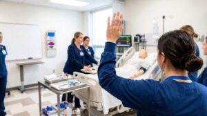 Student nurses practice patient-care skills in a bright laboratory beside textbooks and medical equipment.
